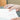 A photograph of a Penco silver pen in a person's hand with a notebook
