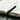 A photo of a black Penco drafting pencil inside of a open notebook