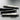 A photo of four Penco pencils on a table with a blurred background