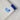 A photo of a corner detail of the label on a peter power stunt kite in white with blue tip