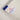 A photo detail of a Peter Powell hand written serial number label in white with blue trim.