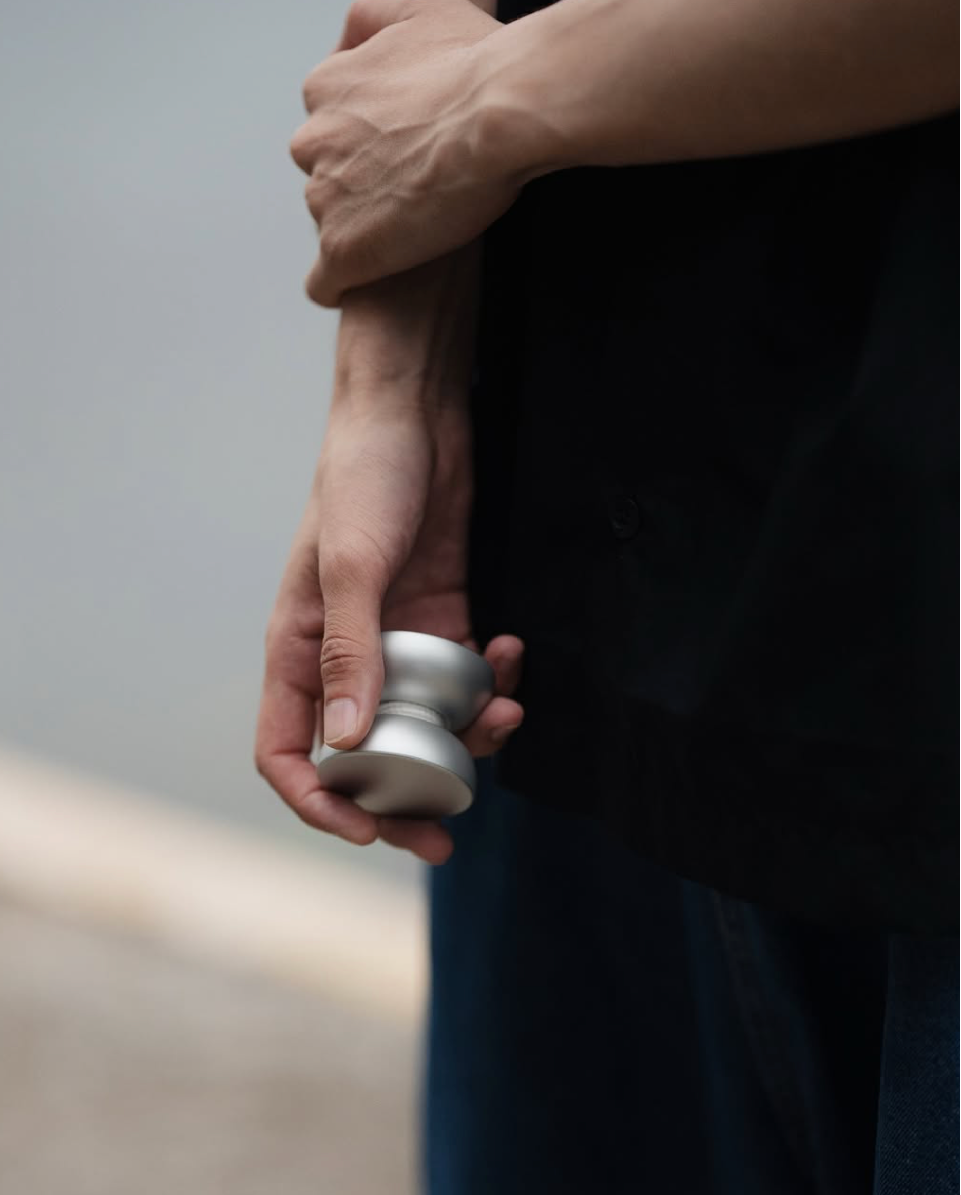 Hand holding a yo-yo against a blurred background