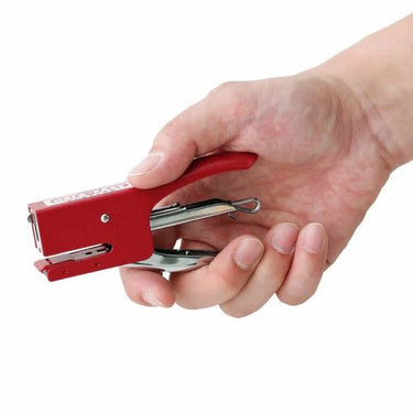 Hand holding a Penco red stapler against a white background