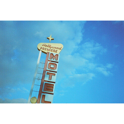 Hollywood Premiere Motel sign against a blue sky