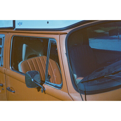 Side view of a vintage vehicle with a clear window panel.
