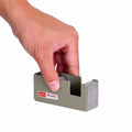 Hand holding a small metal tape dispenser with 'penco Leader' branding on a white background