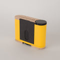 Yellow and black Racina pinhole camera on a gray background from the left