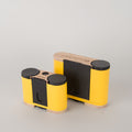Yellow and black Racina Pinhole Cameras in both 35mm and 120 film sizes  on a gray background