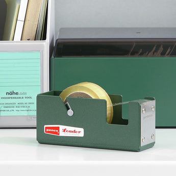 A photo of a green penco tape dispenser with a hammertone finish on a desk.