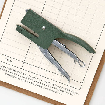 A photo of a penco green hammertone finish stapler on a desk.